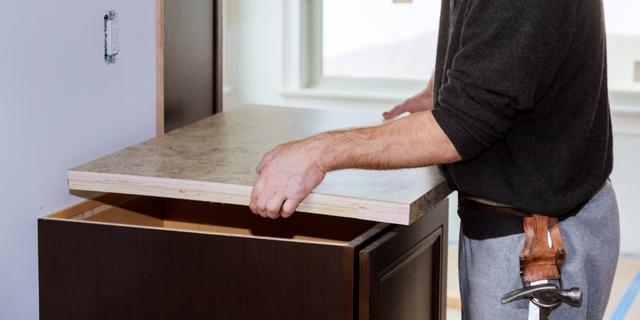 A professional installing a laminate countertop