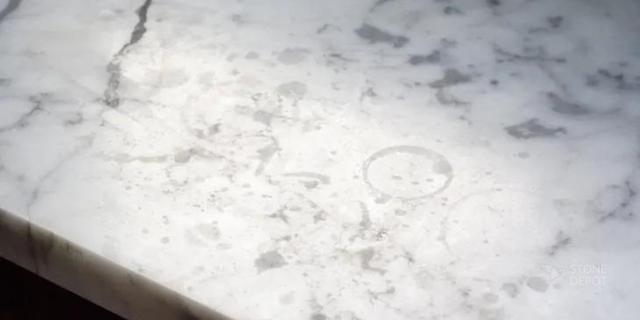 Etch marks on a white marble countertop