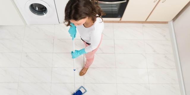 Cleaning marble tiles with dust mop