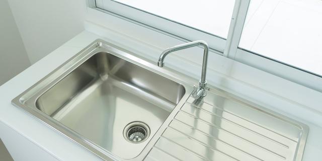 A drop-in sink over a white countertop